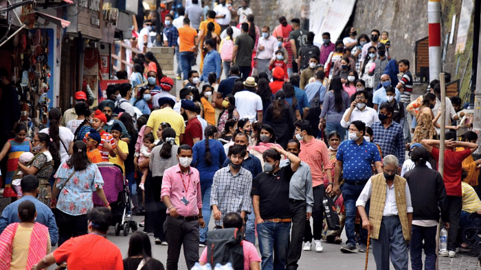 Tourists and locals visit a crowded market area following ease in Covid-induced restrictions, in Shimla. Credit: PTI Photo