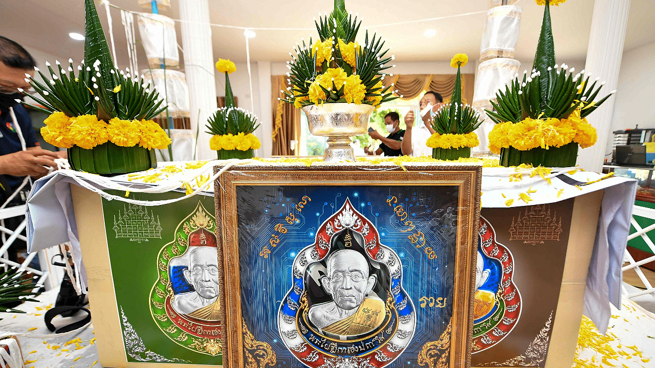 Replicas of the digital amulets bearing an image of the face of Buddhist abbot Luang Pu Heng. Credit: AFP Photo
