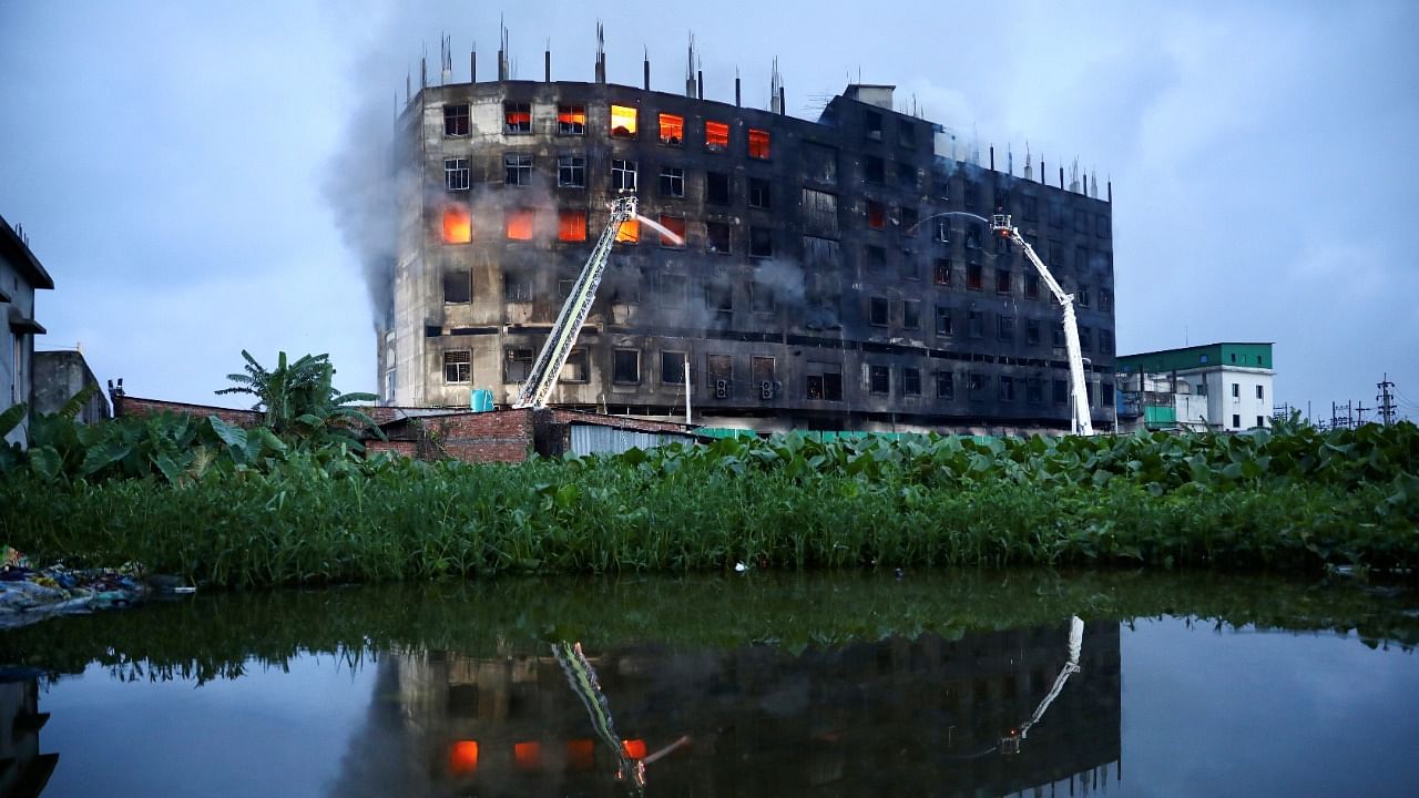 Flames rise the morning after a fire broke out at a factory named Hashem Foods Ltd. in Rupganj near Dhaka. Credit: Reuters Photo