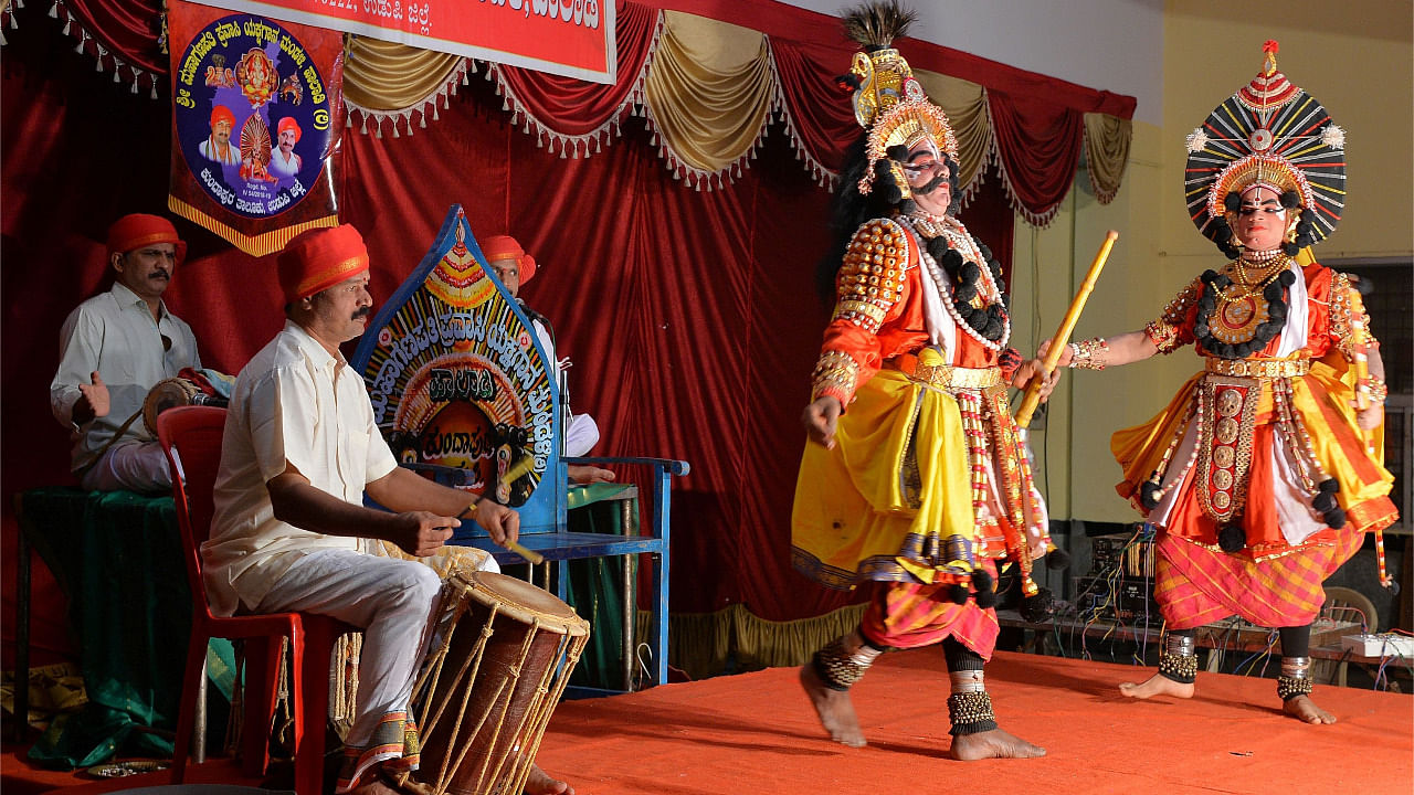 "Yakshagana" artists wearing colourful costumes perform in a theatre in Bengaluru. Credit: AFP Photo