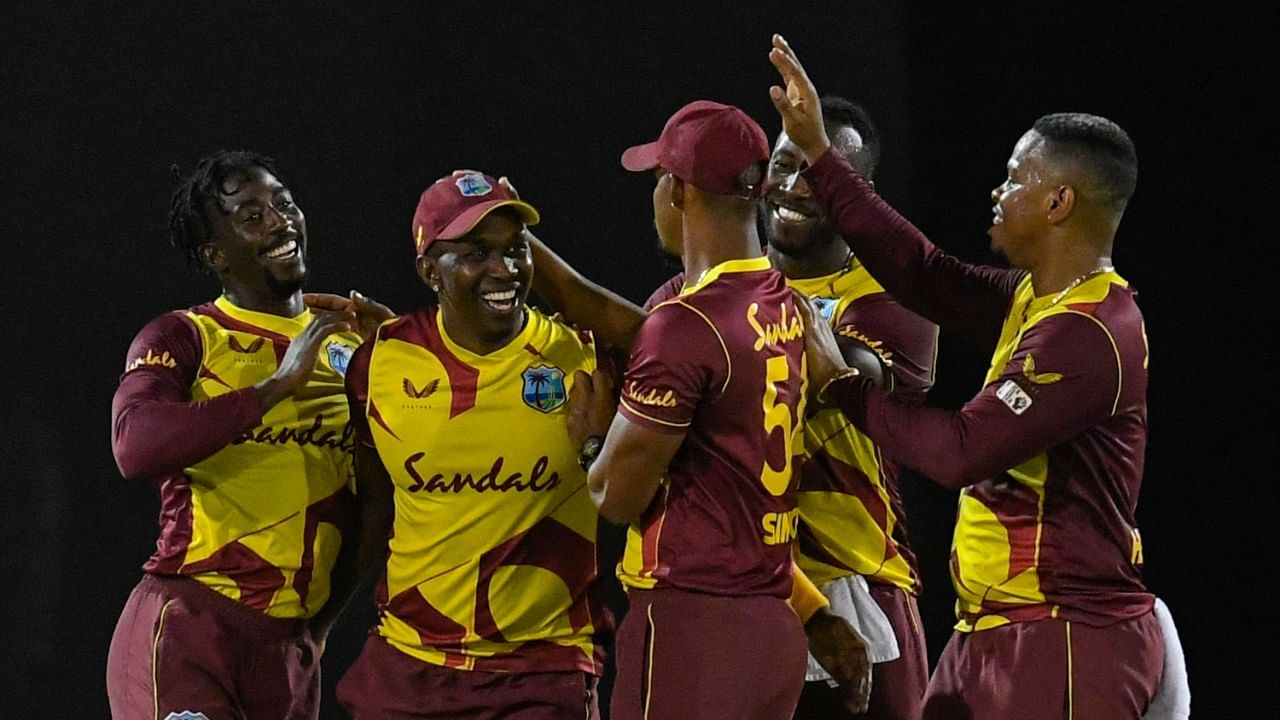 West Indies players celebrate a wicket during the first T20 against Australia. Credit: AFP Photo