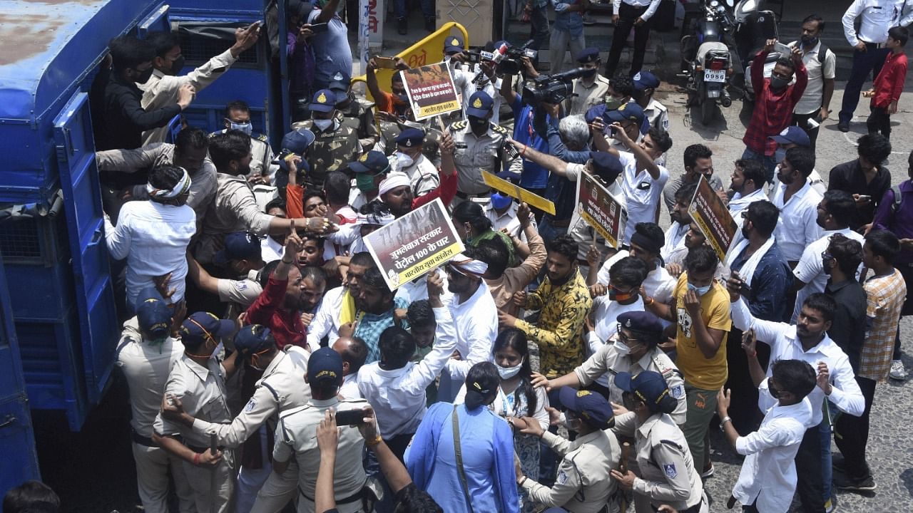 Police personnel detain Youth Congress activists during a protest against a hike in the LPG and fuel prices. Credit: PTI Photo