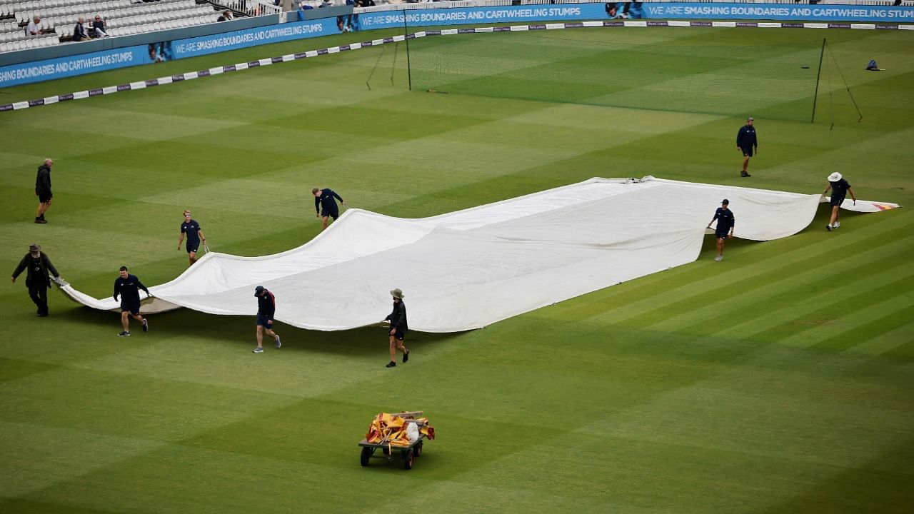 Groundstaff move the covers as rain delays the start of play ahead of the second one day international (ODI) cricket match between England and Pakistan at Lord's cricket ground in London. Credit: AFP Photo