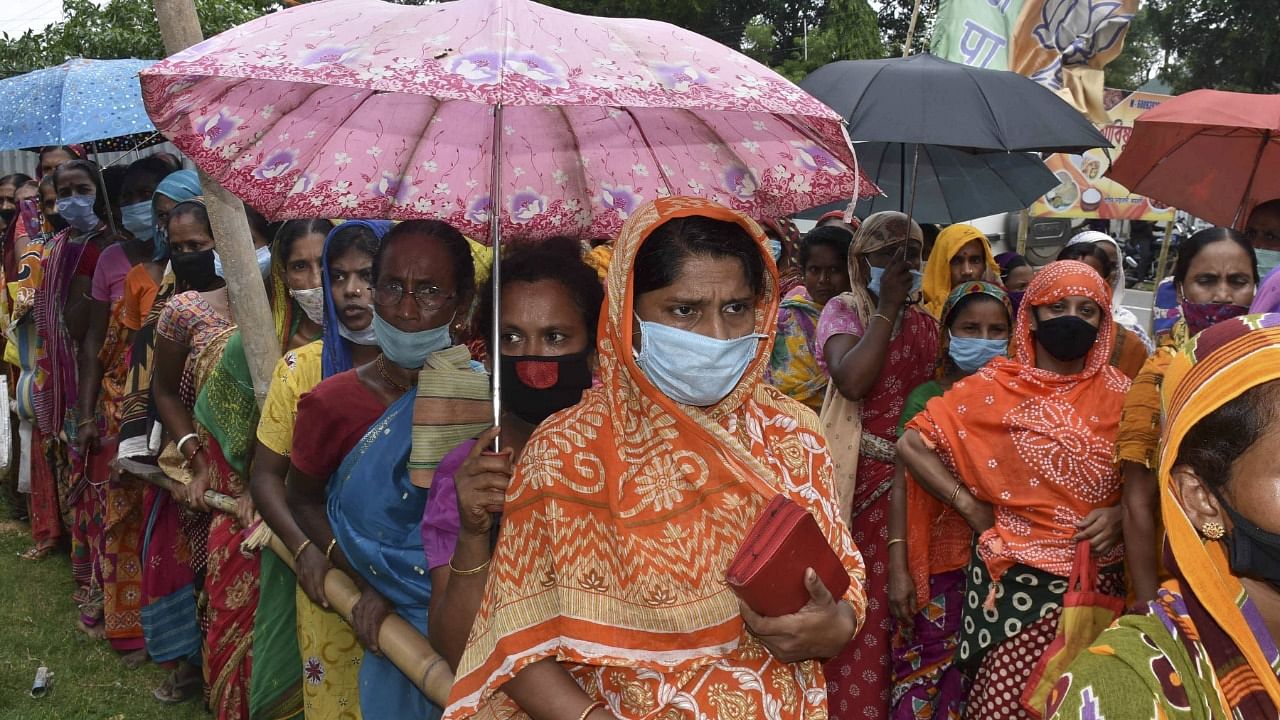 Needy people wait in queues to receive free food packages under 'Chief Minister Covid Special Relief Package Scheme', in Agartala, Friday, June 25, 2021. Credit: PTI Photo