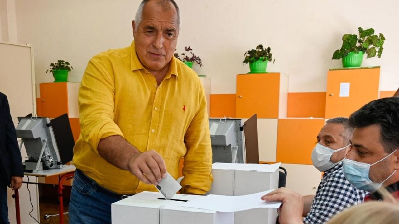 Former Bulgaria's Prime Minister and leader of centre-right GERB party, Boyko Borisov (C) casts his ballot at a polling station during the country's parliamentary election in Sofia on July 11, 2021. Credit: AFP Photo