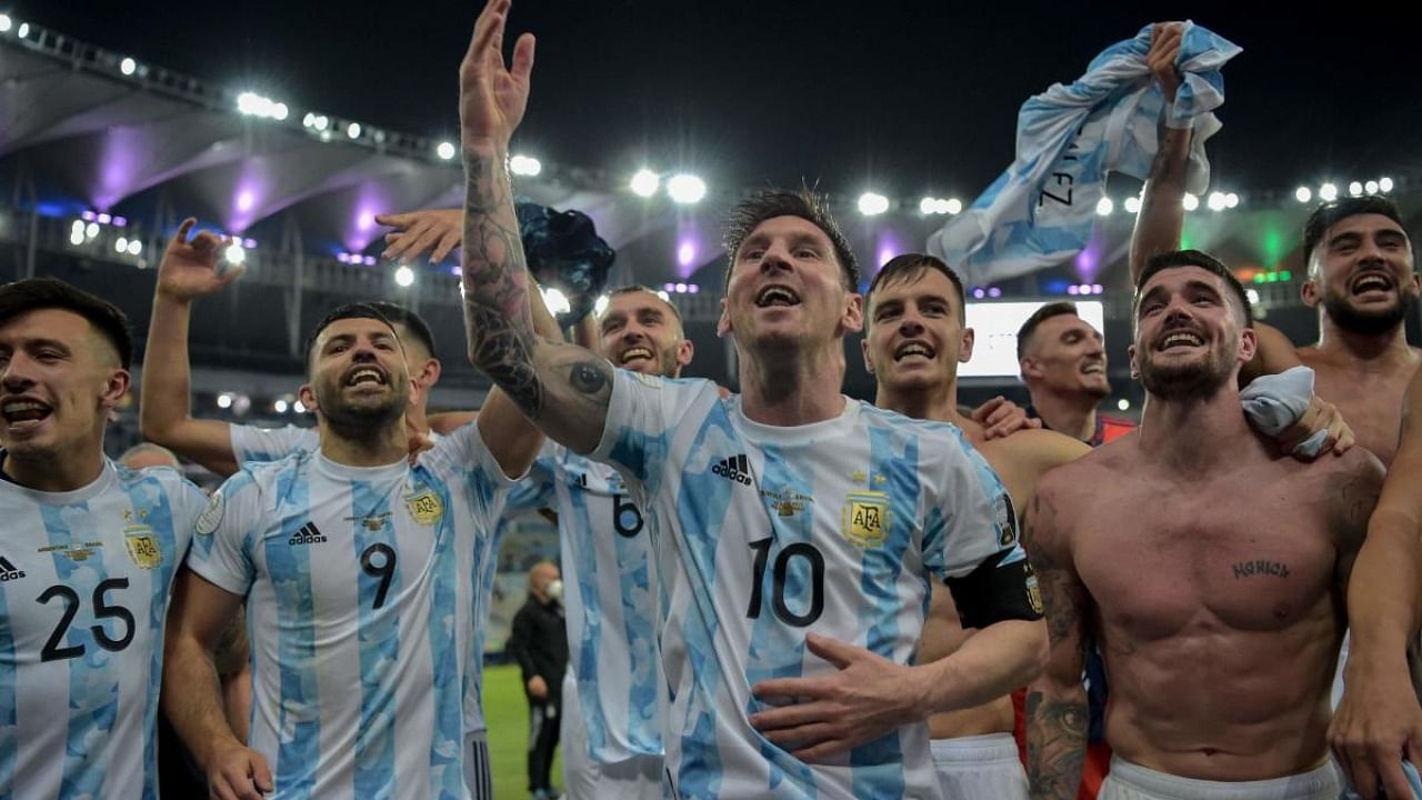 Argentina's Lionel Messi (C) and teammates celebrate after winning the Conmebol 2021 Copa America football tournament final match against Brazil at Maracana Stadium in Rio de Janeiro, Brazil. Credit: AFP Photo