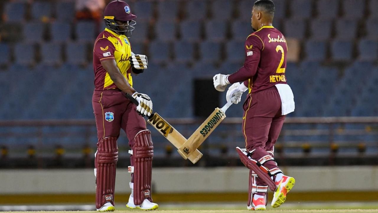 Dwayne Bravo (L) and Shimron Hetmyer (R) of West Indies partnership during the 2nd T20I between Australia and West Indies at Darren Sammy Cricket Ground, Gros Islet, Saint Lucia. Credit: AFP Photo