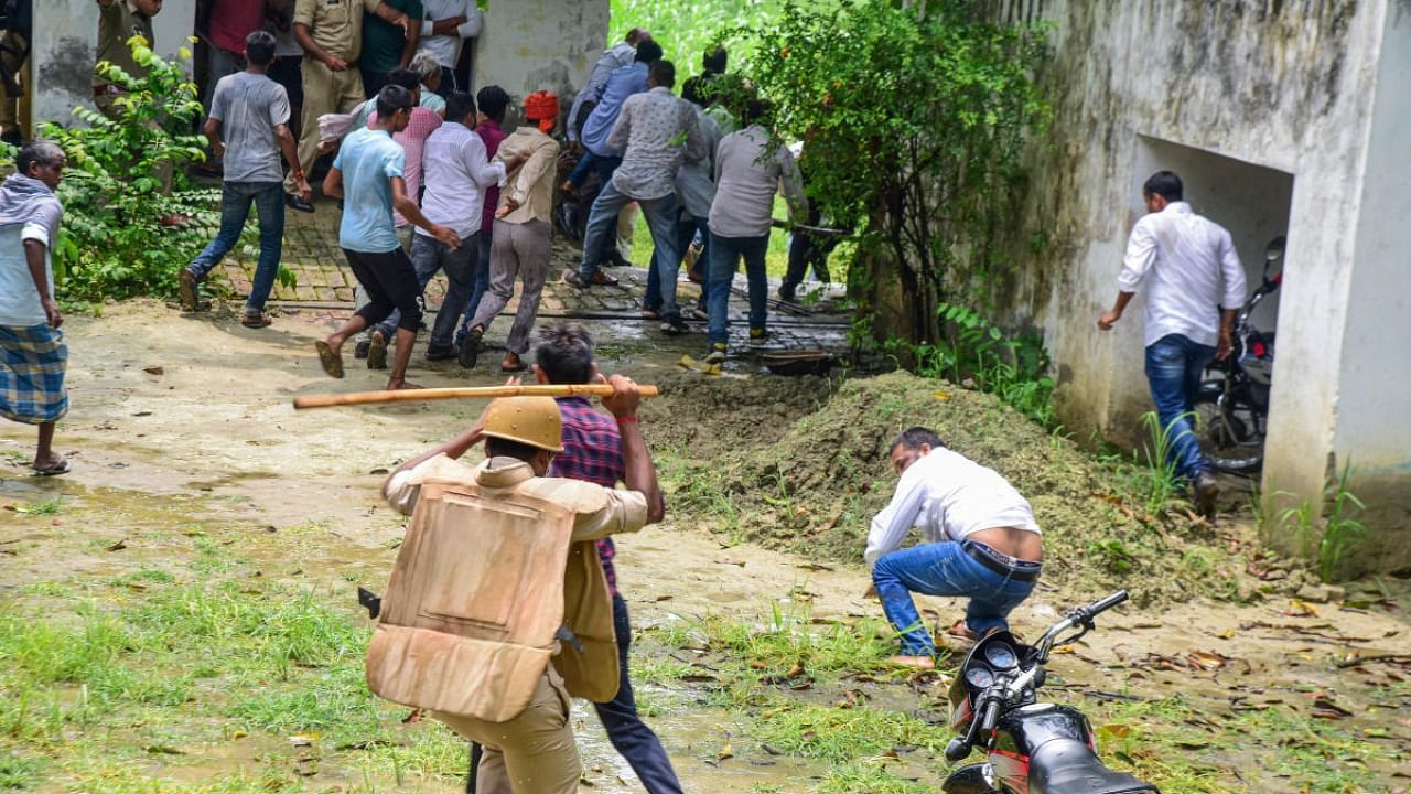 Police personnel baton charge on locals allegedly causing ruckus during the block head elections, in Ayodhya district. Credit: PTI Photo