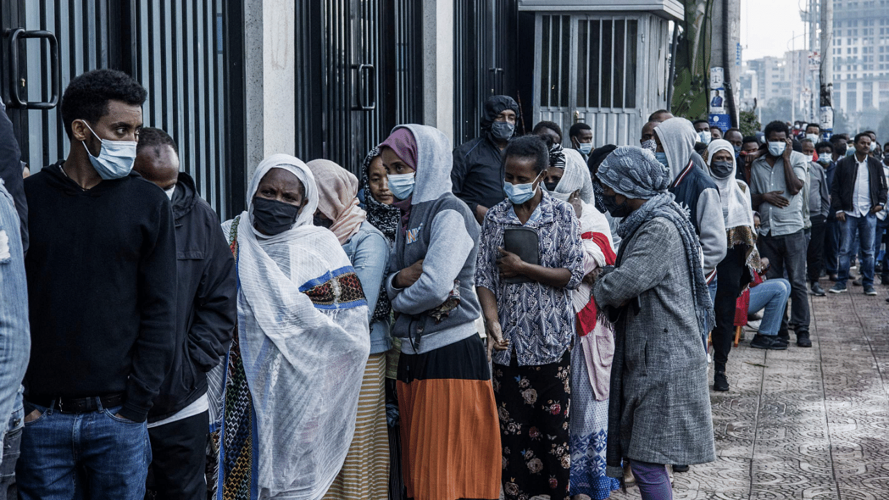 A long queue of voters wait on the sidewalk outside a polling station in Addis Ababa. Credit: AFP Photo