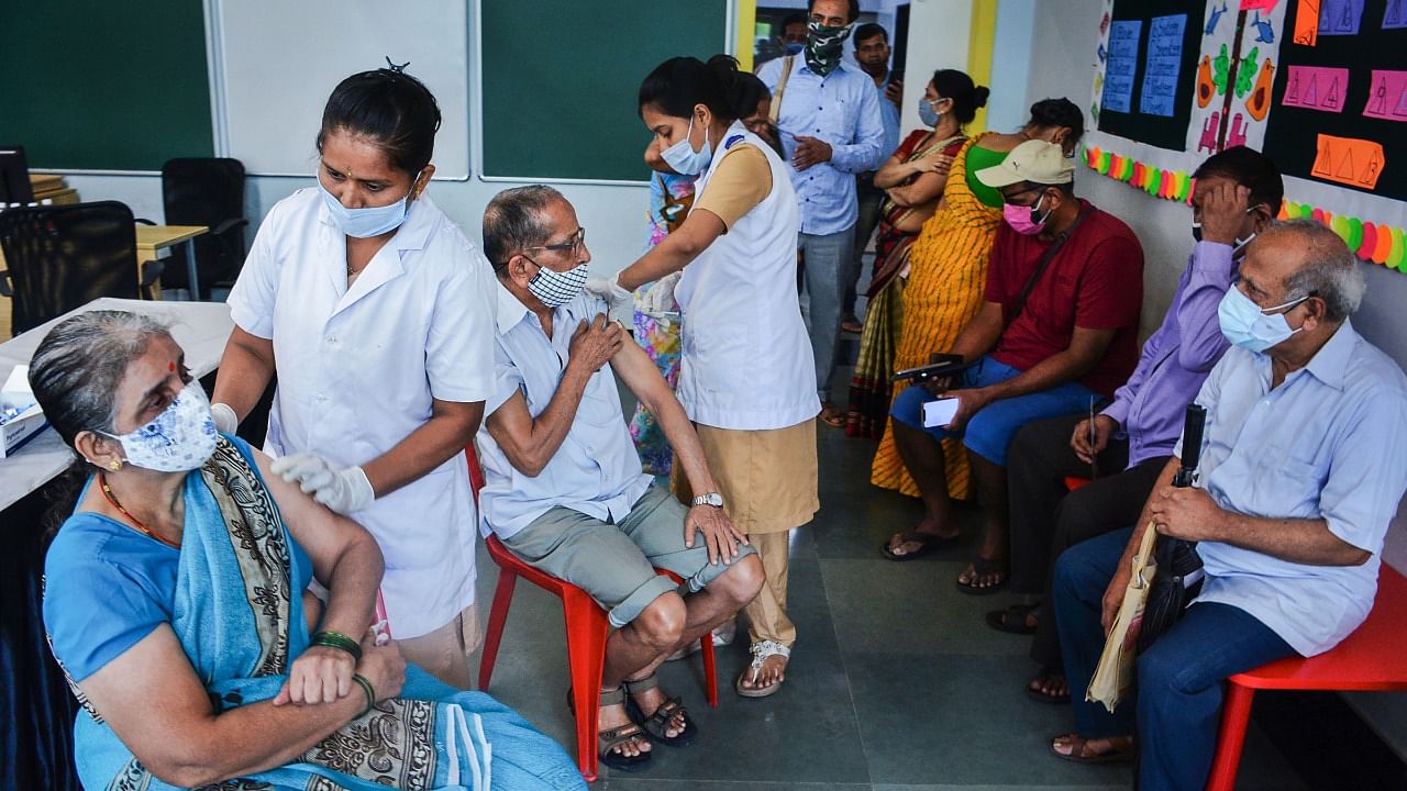 Health workers administer Covid-19 vaccine dose to senior citizens, at a school turned vaccination centre in Thane, Wednesday, July 7, 2021. Credit: PTI Photo