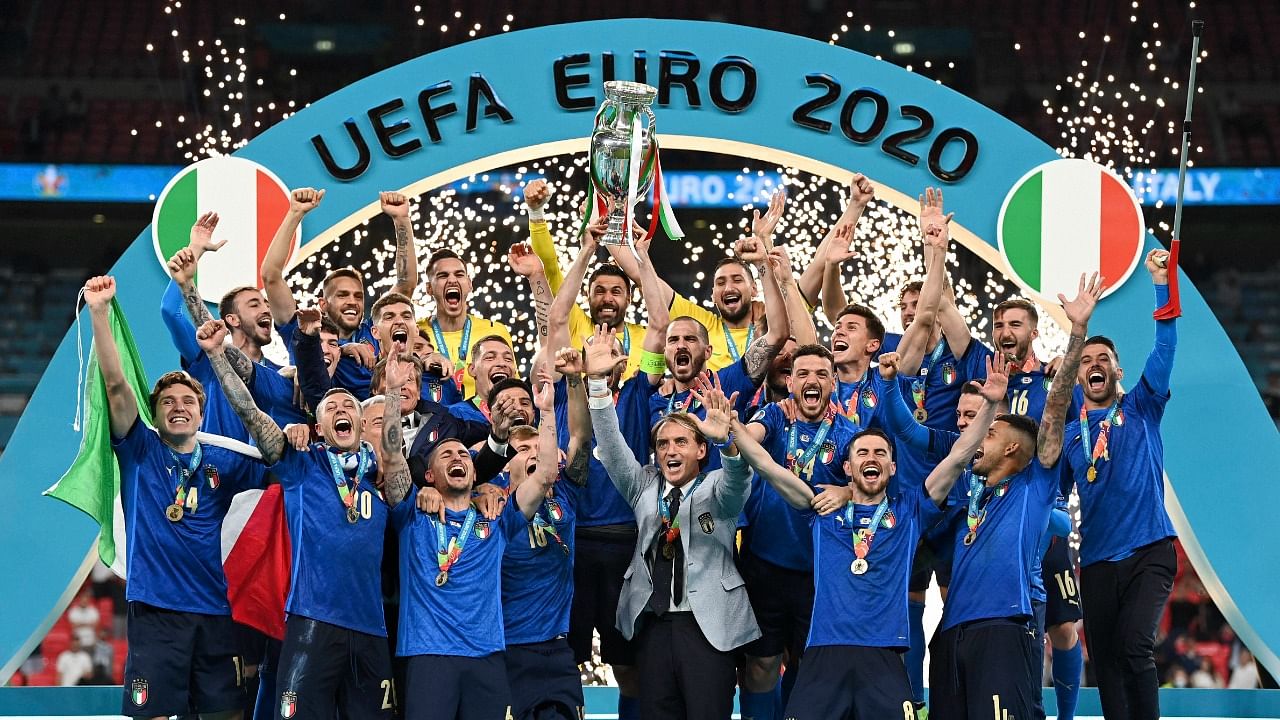 Italy's team celebrates with the Euro 2020 trophy. Credit: AP Photo