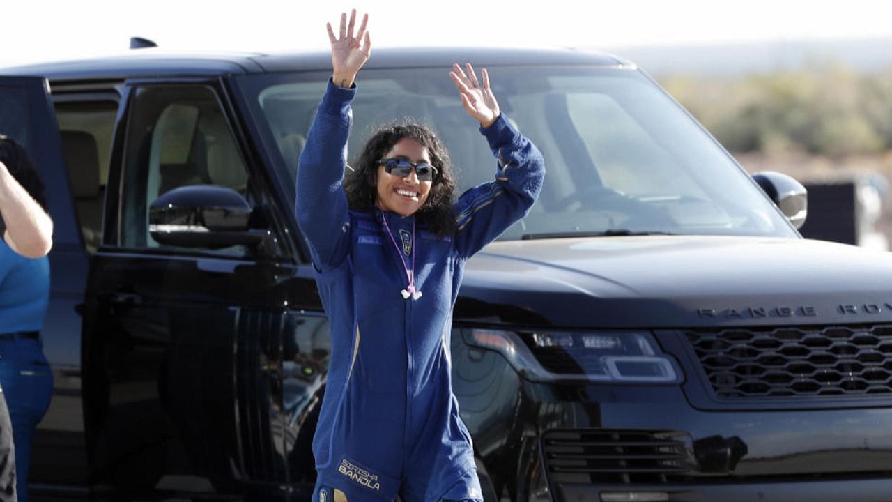 Sirisha Bandla waves to the crowd before heading to board the rocket plane on July 11, 2021. Credit: PTI Photo