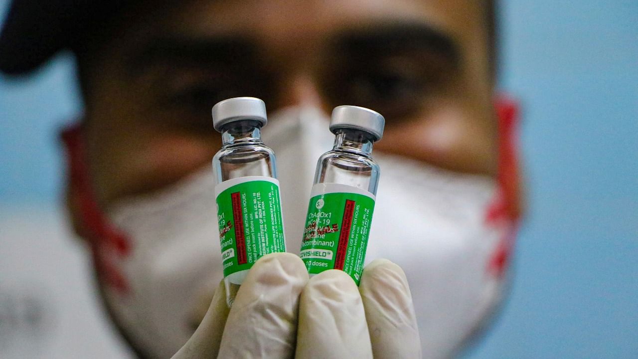 A medic shows vials of the Covishield vaccine. Credit: PTI Photo