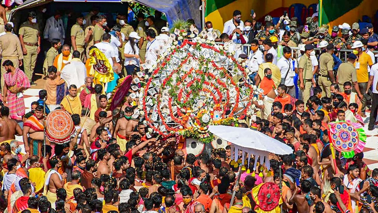 Devotees perform rituals during the annual Rath Yatra festival in Puri. Credit: PTI Photo