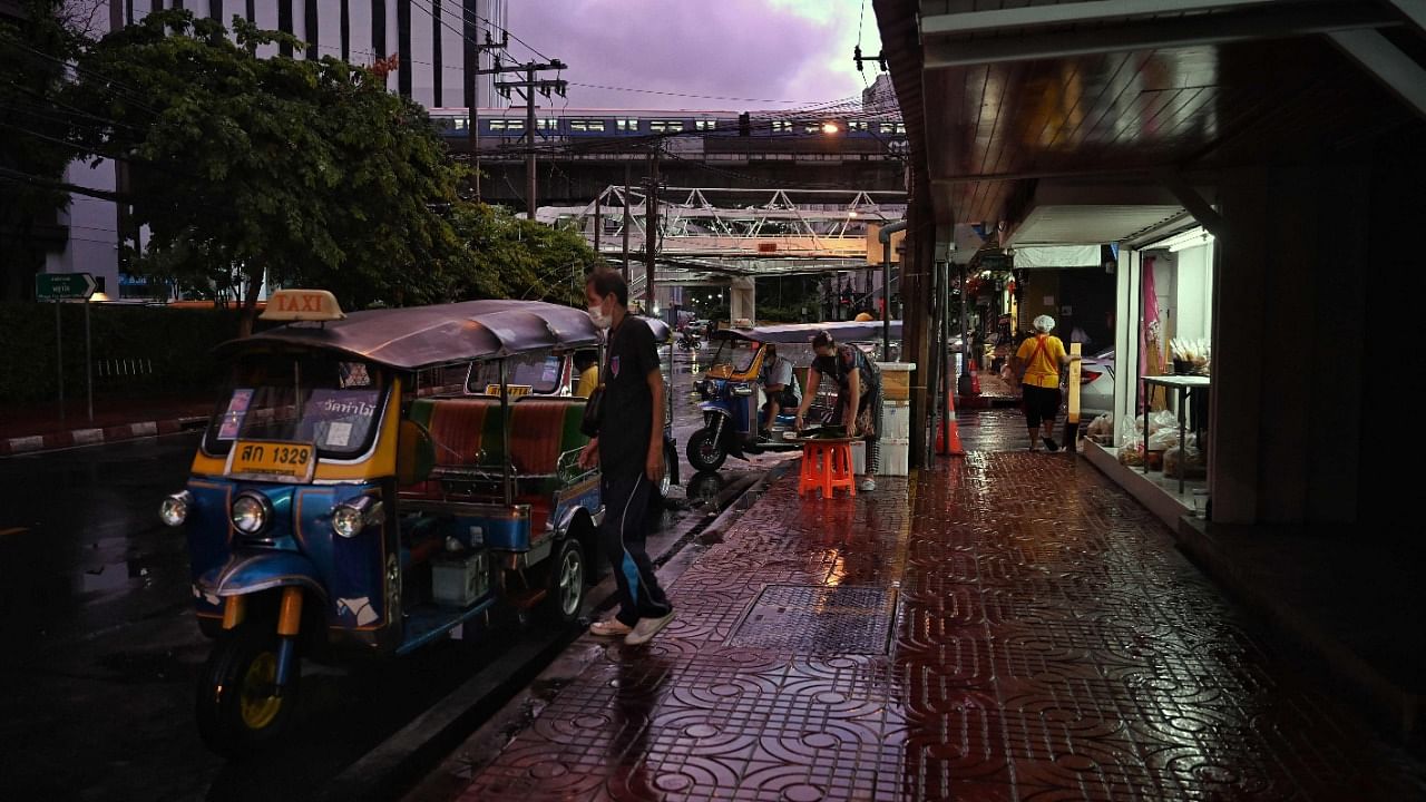 Vendors set up stalls on a street in Bangkok on July 12, 2021, on the first day of stricter lockdown restrictions to try to contain the spread of the Covid-19 coronavirus. Credit: AFP Photo