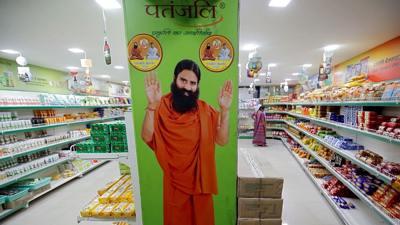 A hoarding with an image of Baba Ramdev is seen inside a Patanjali store. Credit: Reuters Photo