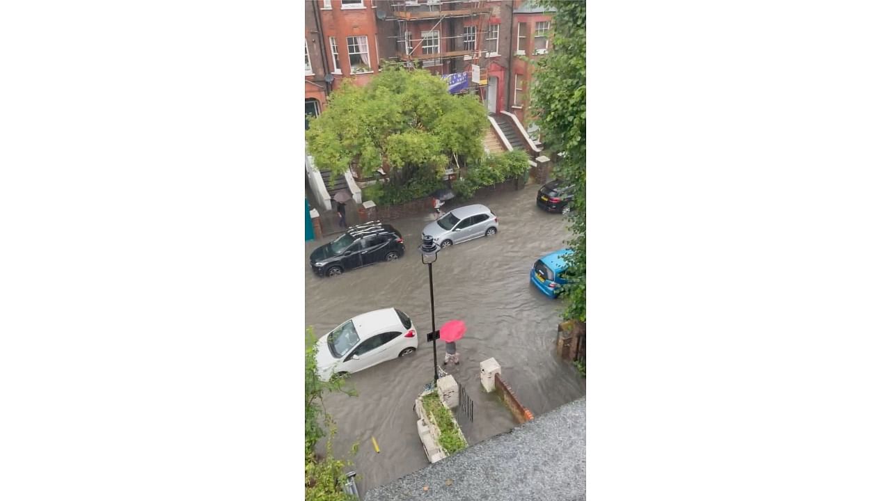 Footage of the storm’s aftermath showed cars submerged over their wheels and people huddled under awnings on Portobello Road. Credit: Reuters Photo