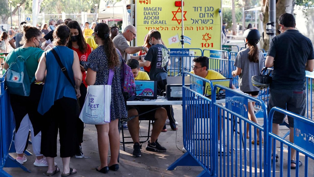 Israeli youths arrive to receive a dose of the Pfizer/BioNTech Covid-19 vaccine from the Magen David Adom during a campaign by the Tel Aviv-Yafo Municipality. Credit: AFP file photo