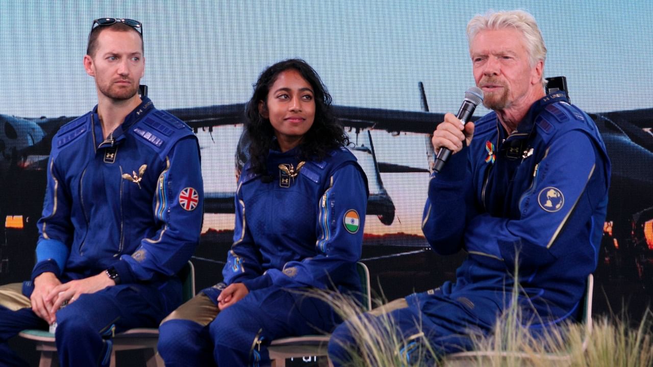 Truth or Consequences: Richard Branson, right, answers questions while crewmates Sirisha Bandla and Colin Bennett listen during a news conference at Spaceport America near Truth or Consequences, New Mexico. Credit: AP/PTI Photo