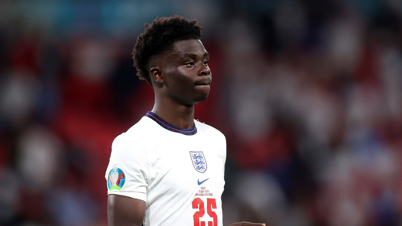 England's Saka looks dejected after losing the penalty shootout. Credit: Reuters Photo