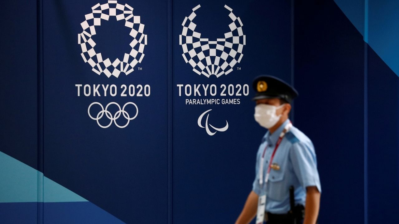A policeman walks past Tokyo 2020 Olympic signage at the Main Press Center in Tokyo. Credit: Reuters Photo