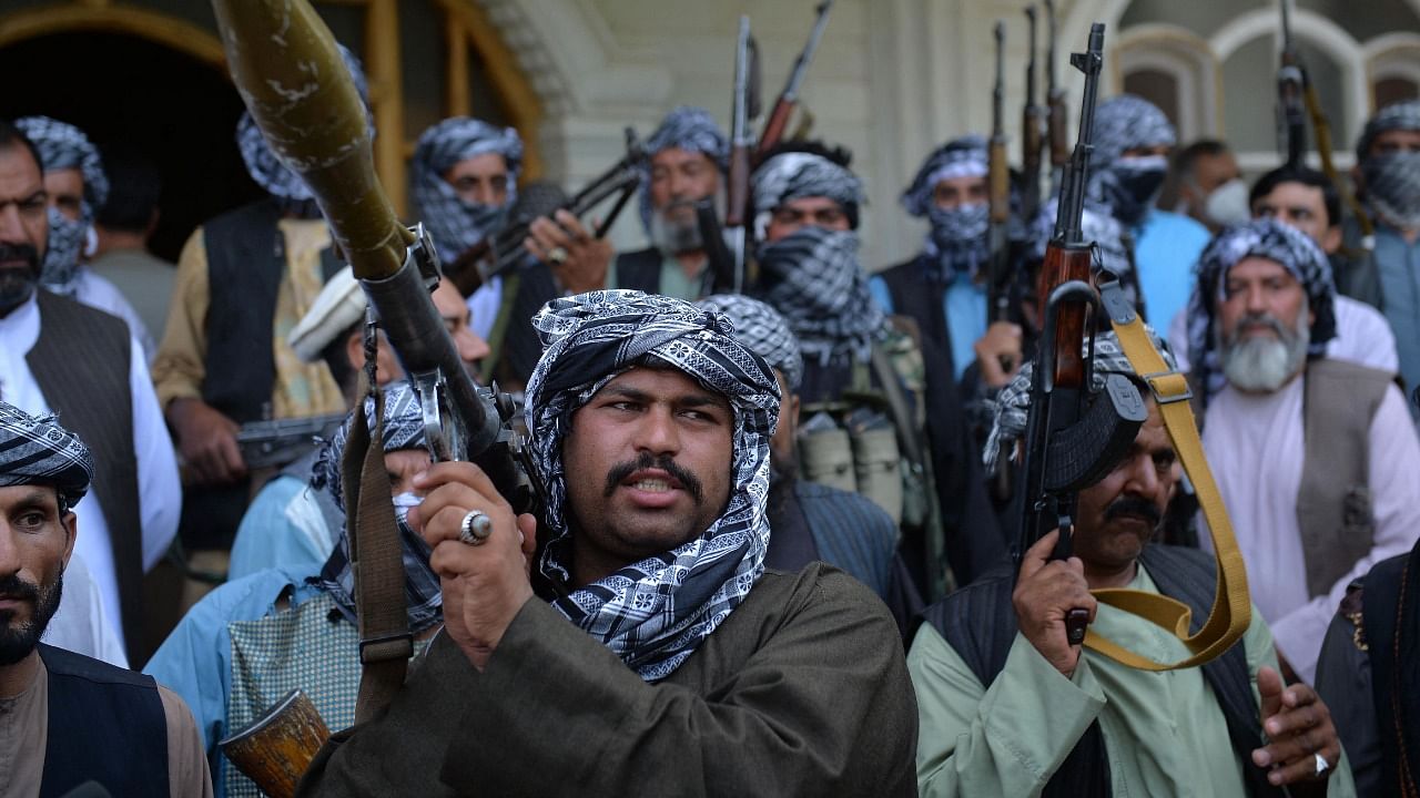 Afghan militia gather with their weapons to support Afghanistan security forces against the Taliban. Credit: AFP Photo