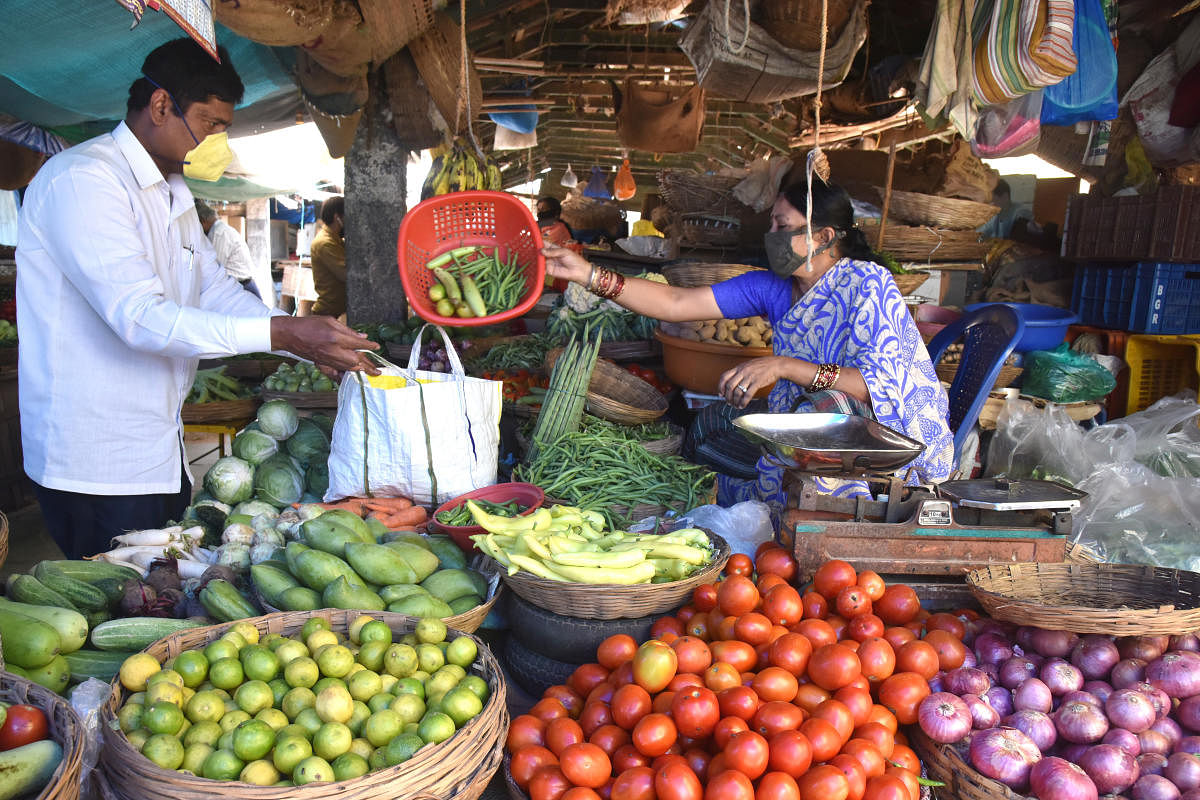 People purchase vegetables at Avenue Road market in Bengaluru on Thursday, April 16, 2020. DH Photo/S K Dinesh