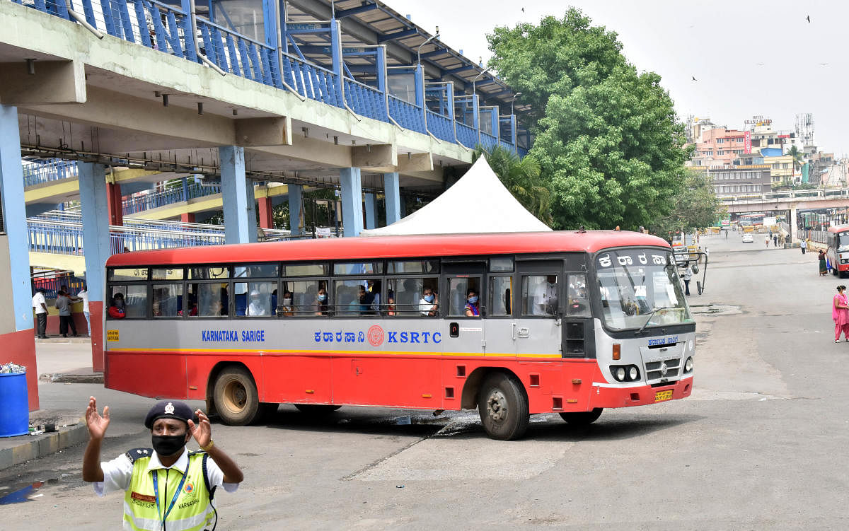 Volunteers throw flowers to migrants workers who using KSRTC bus for going home town during last day services of KSRTC at the Lockdown by Covid 19, at Majestic in Bengaluru on Thursday, May 07, 2020. (Photo by Janardhan B K)