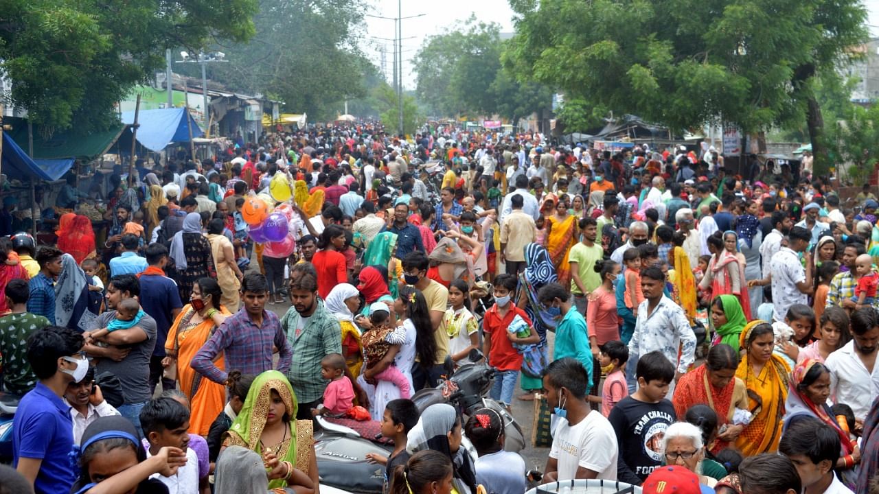 People flout social distancing norms as they visit a crowded annual fair after authorities eased Covid-induced lockdown, in Agra, Monday, July 12, 2021. Credit: PTI Photo