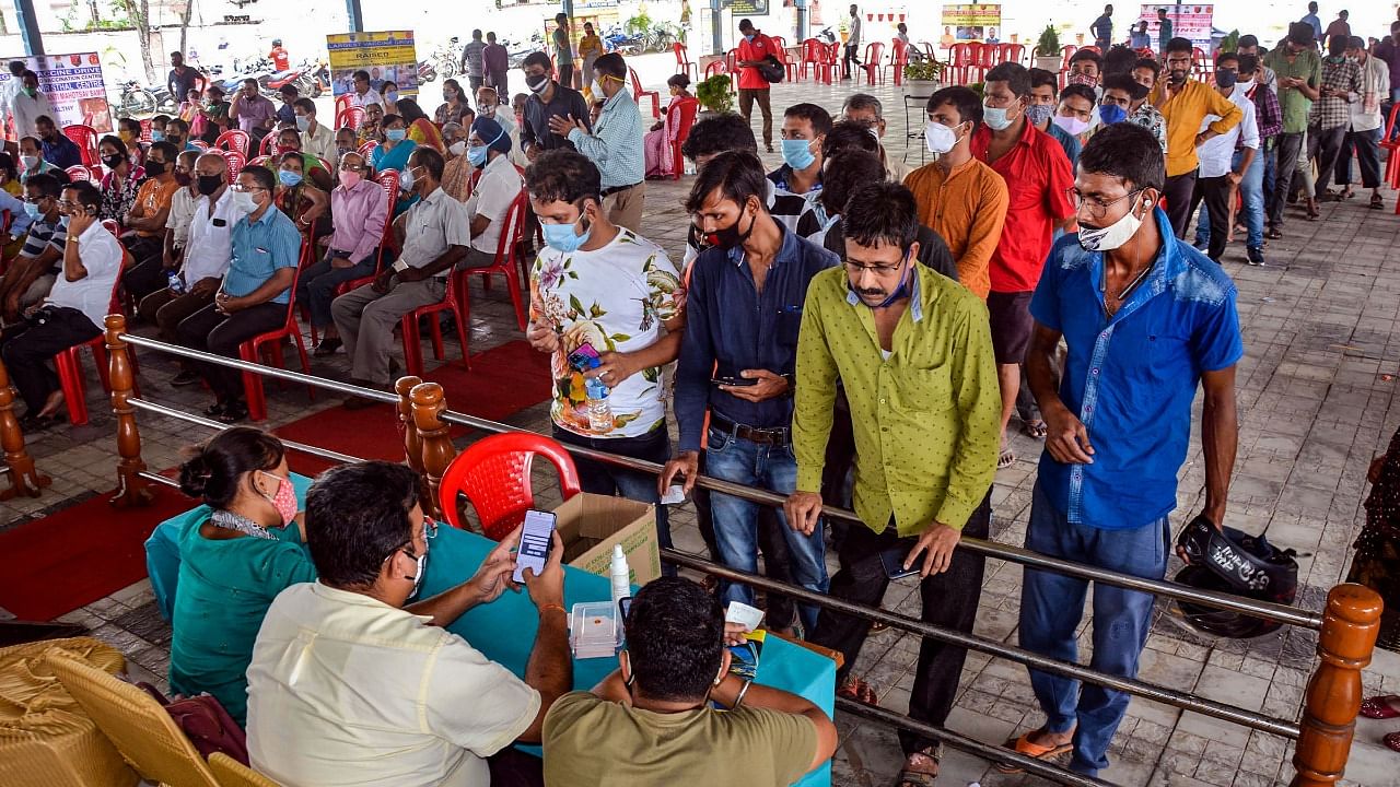 Beneficiaries wait in a queue to receive Covid-19 vaccine dose during a vaccination drive in Guwahati, Tuesday, July 13, 2021. Credit: PTI Photo