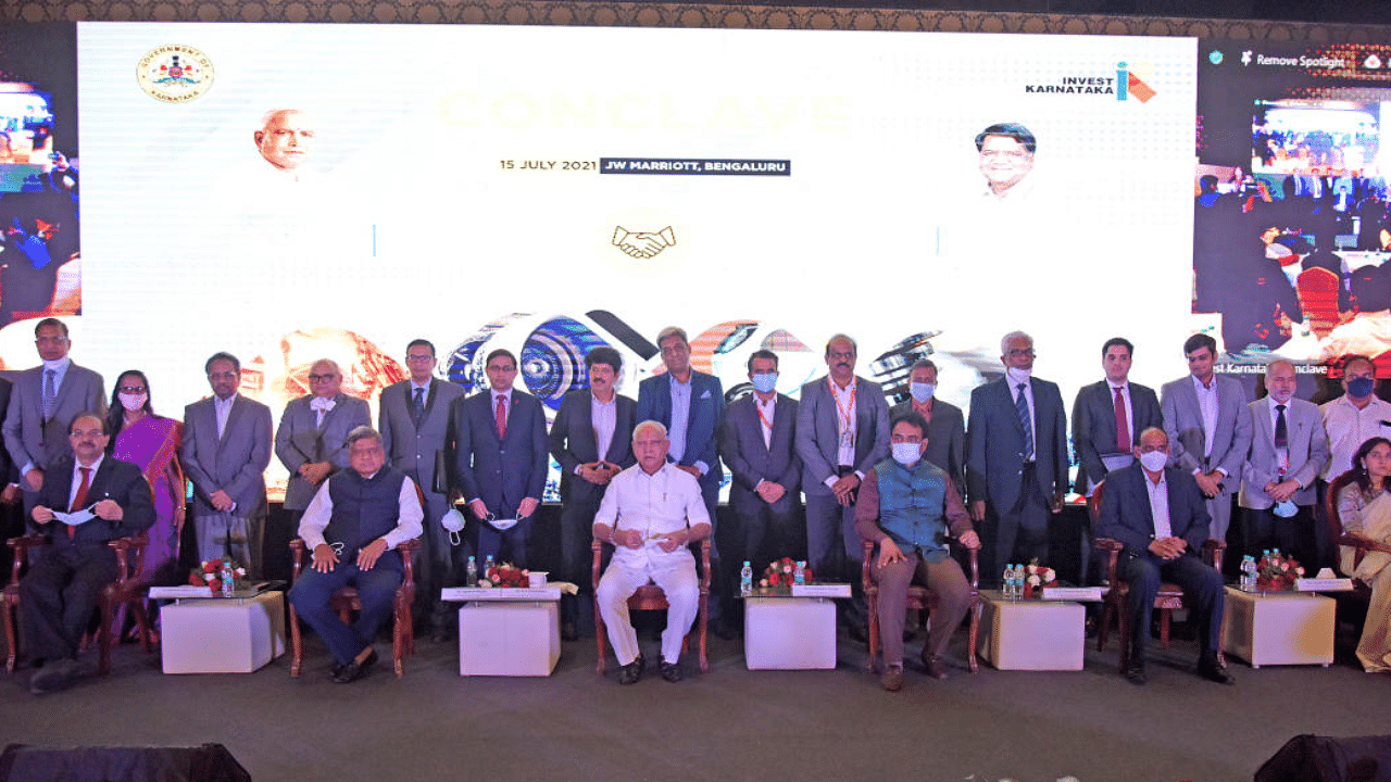 Chief Minister BS Yediyurappa, Large & Medium Scale Industries Minister Jagadish Shettar, Deputy Chief Minister CN Ashwath Narayan along with officials and industry leaders from various companies who singed MoU during the Invest Karnataka pose for a photo in Bengaluru. Credit: DH Photo/Pushkar V
