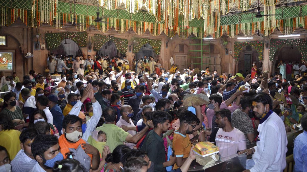 Devotees, flouting COVID appropriate behaviour, pay obeisance at Bankey Bihari Temple on 'Shani Amavasya 2021', in Mathura district, Saturday, July 10, 2021. Credit: PTI Photo