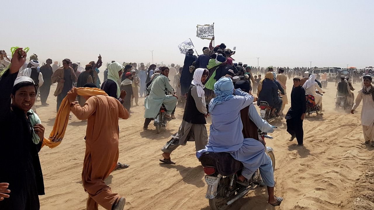 People gather near the Friendship Gate crossing point in the Pakistan-Afghanistan border town of Chaman. Credit: Reuters Photo