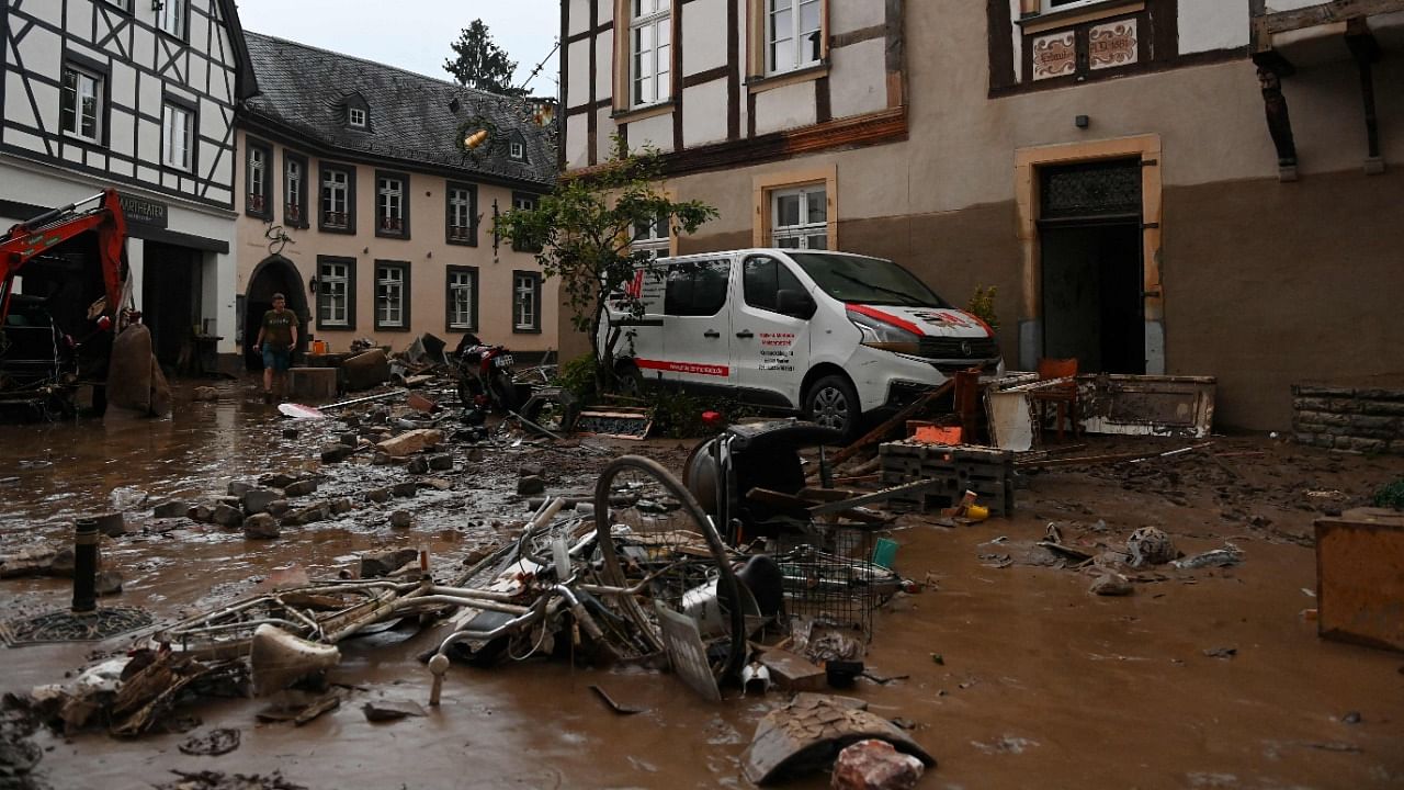 A damaged car and bicycles are pictured in a muddy street in Ahrweiler-Bad Neuenahr, western Germany. Credit: AFP Photo