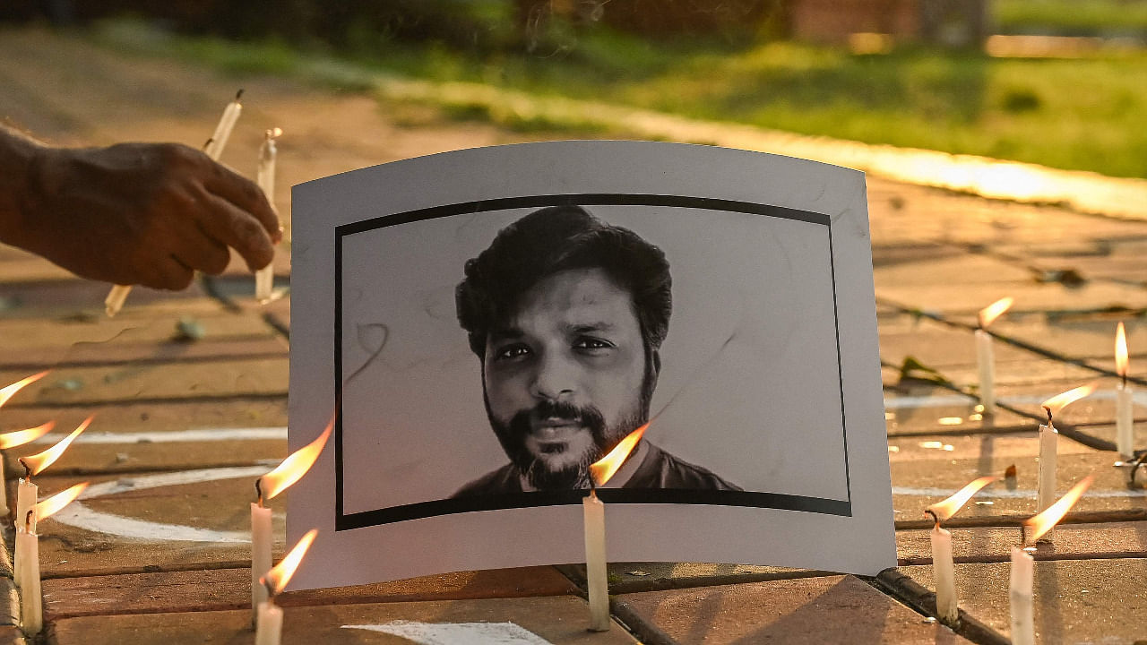 Candles are placed by journalists next to the portrait of Reuters journalist Danish Siddiqui as a tribute in Kolkata. Credit: AFP Photo
