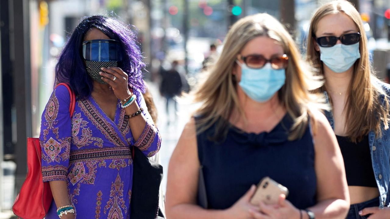 People wearing face protective masks walk on Hollywood Blvd during the outbreak of the coronavirus disease, in Los Angeles, California. Credit: Reuters Photo