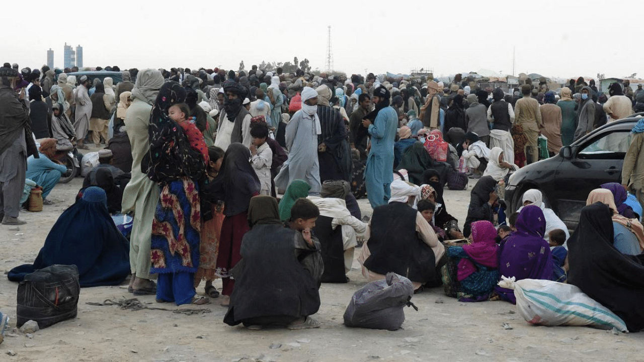 Stranded people wait for the reopening of border crossing point in the Pakistan's border town of Chaman. Credit: AFP Photo