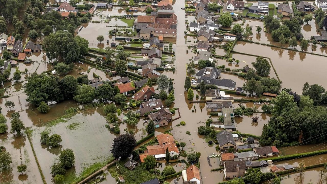 This aerial view taken in Brommelen shows the flooded area around the Meuse after a levee of the Juliana Canal broke. Credit: AFP Photo