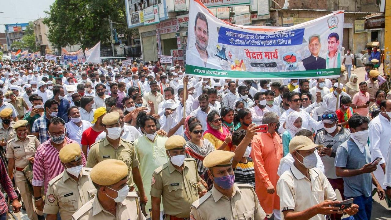 Congress Party activists take out a march as they protest against the hike in fuel and LPG prices, in Jaipur. Credit: PTI Photo
