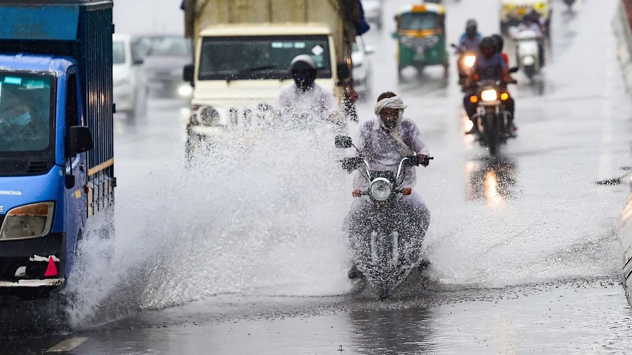 Vehicles ply on a waterlogged road after heavy rains in New Delhi. Credit: PTI photo