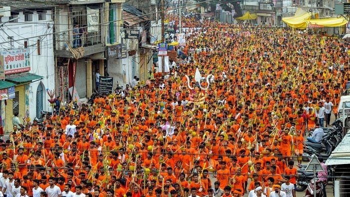 Shiva devotees 'kawadias' arrive after they collect Narmada water to perform rituals during the holy month of 'Shrawan', in Jabalpur. Credit: PTI File Photo