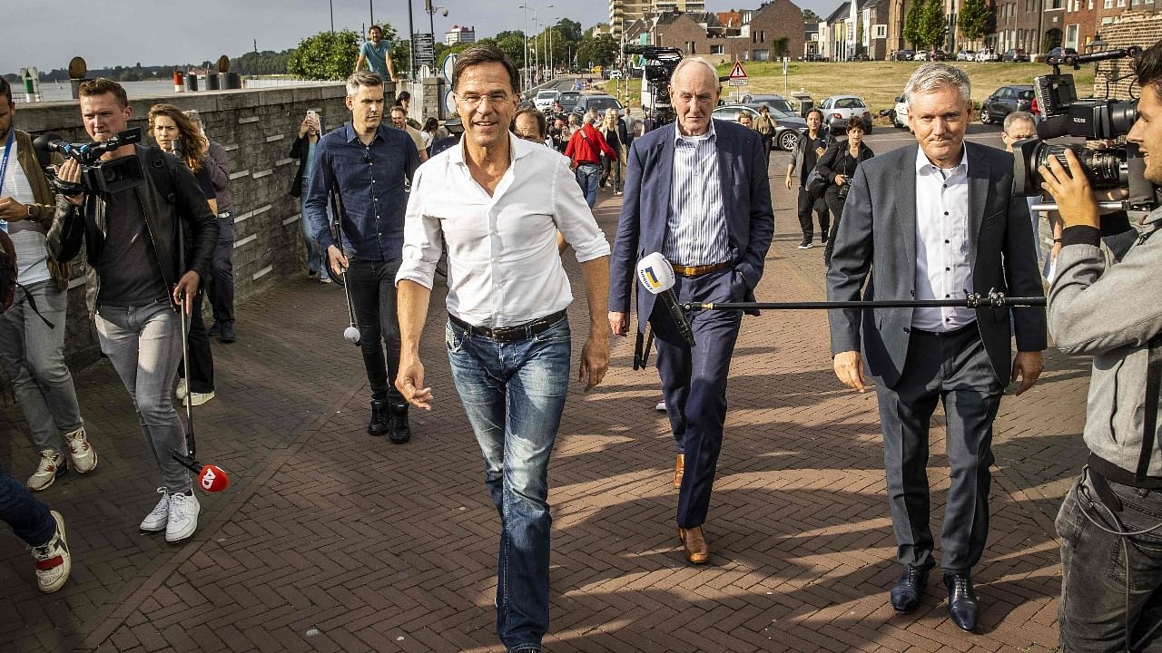Dutch Prime Minister Mark Rutte (L) walks Governor Johan Remkes (C) and Mayor of Venlo Antoin Scholten (R) as he visits flooded areas in Venlo. Credit: AFP Photo