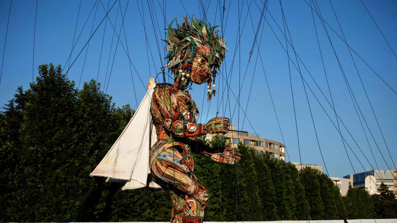 A 10-metre high (33 ft.) giant puppet named 'MOCCO', brought down from the Tohoku region in northeastern Japan which was devastated in 2011 by an earthquake, tsunami and nuclear disaster, is displayed at a media event as part of the Tokyo 2020 Nippon Festival in Tokyo. Credit: AFP Photo