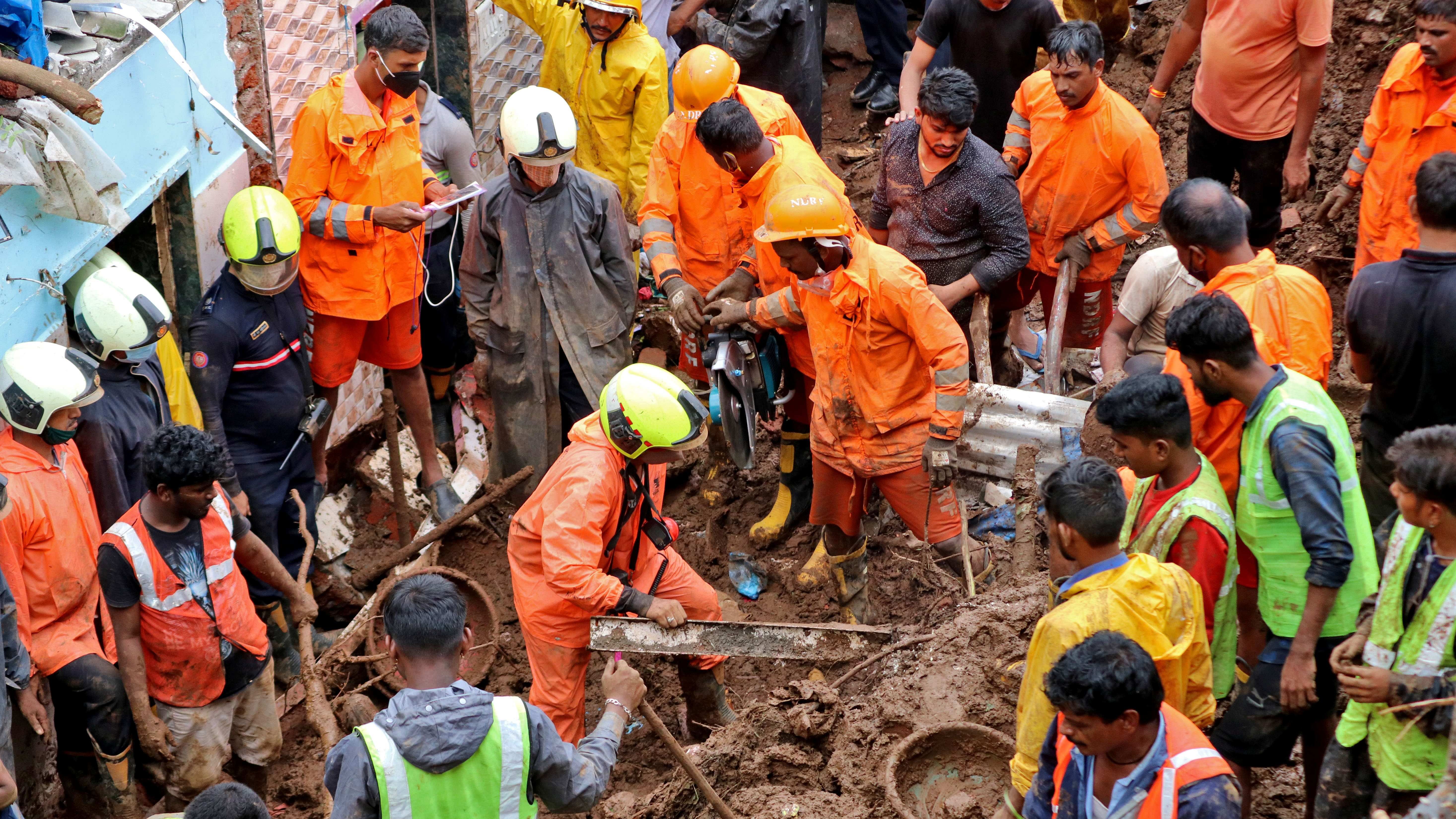 Rescue workers remove debris as they search for survivors after a residential house collapsed due to landslide caused by heavy rainfall in Mumbai. Credit: Reuters