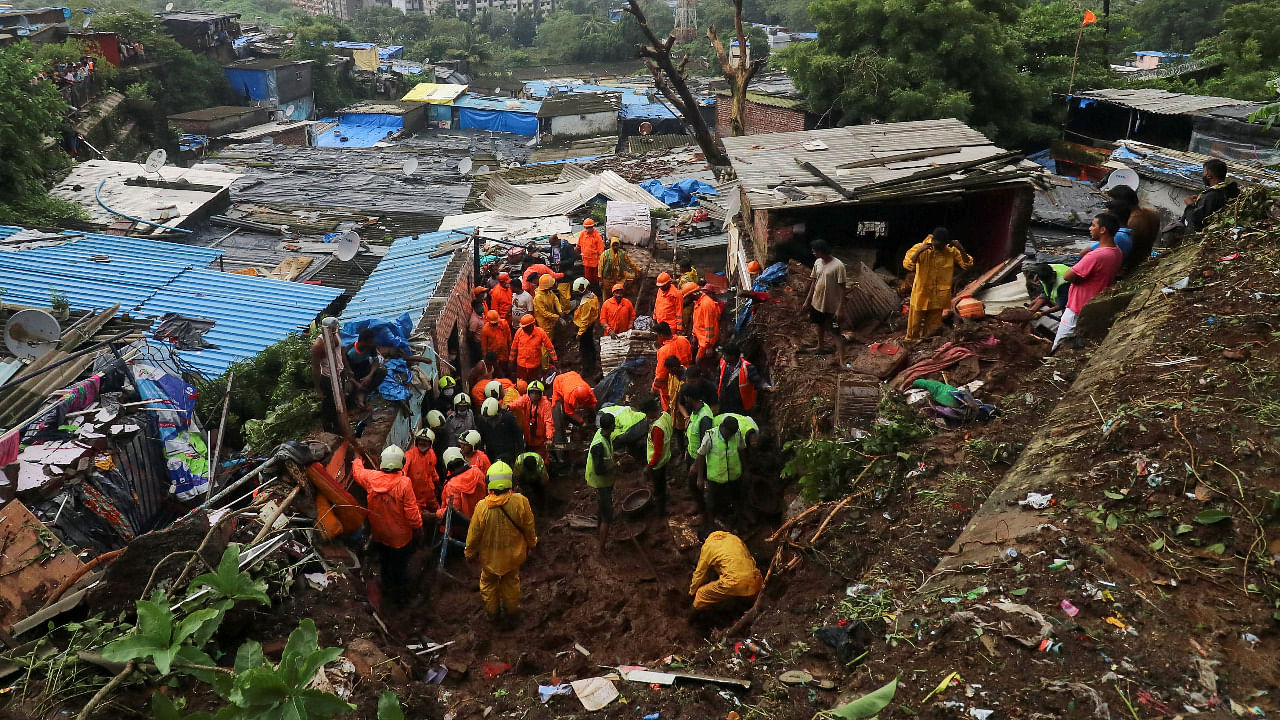 Rescue workers search for survivors after a residential house collapsed due to landslide caused by heavy rainfall in Mumbai. Credit: Reuters Photo