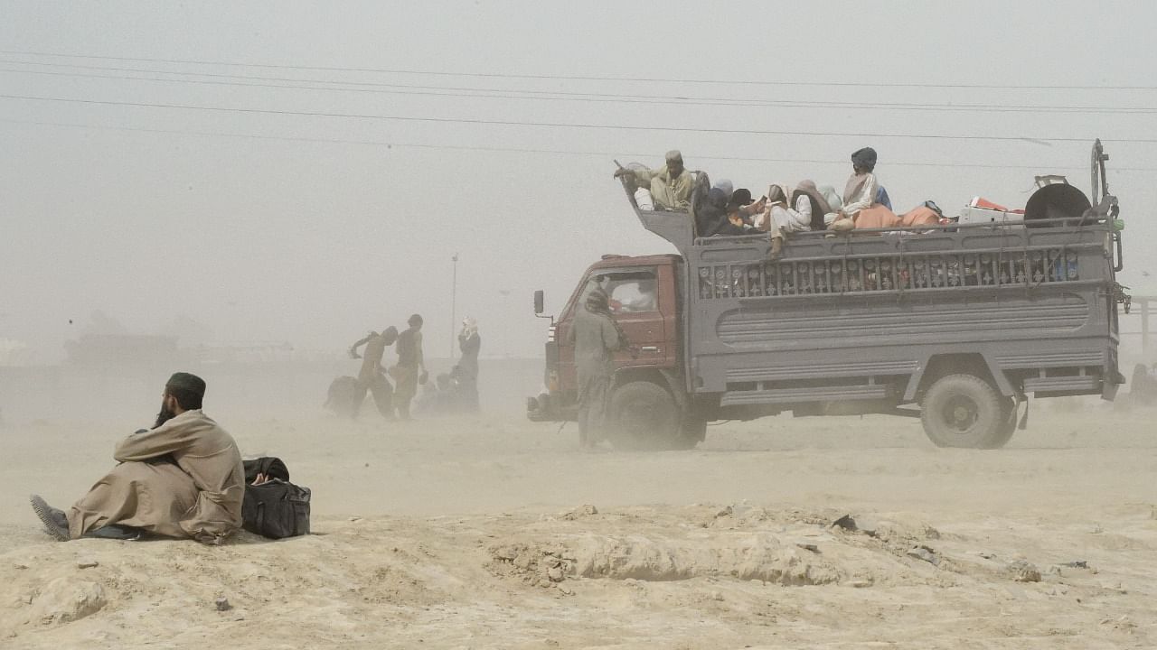 Stranded people wait for the reopening of border crossing point in the Pakistan's border town of Chaman on July 16, 2021, following clashes between Afghan forces and Taliban fighters in Spin Boldak to retake the key border crossing with Pakistan. Credit: AFP Photo