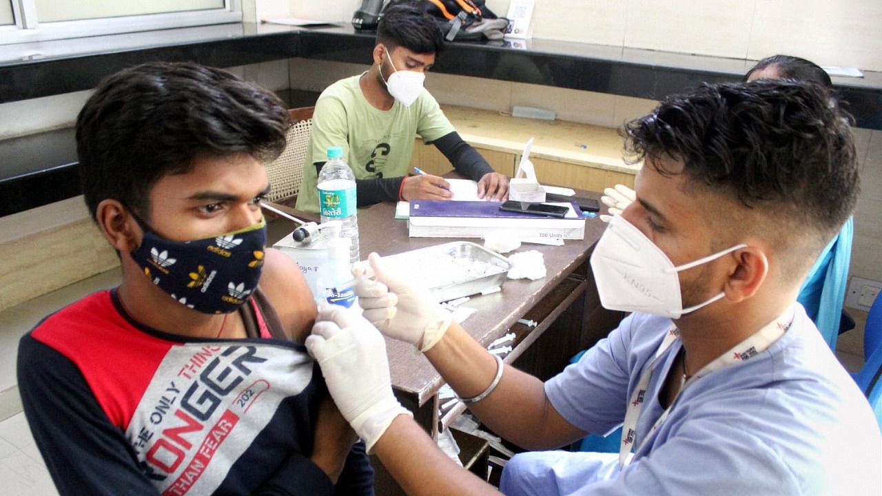 A health worker administers a dose of Sputnik V coronavirus vaccine to a beneficiary at a vaccination centre, in Gurugram, Saturday, July 17, 2021. Credit: PTI Photo