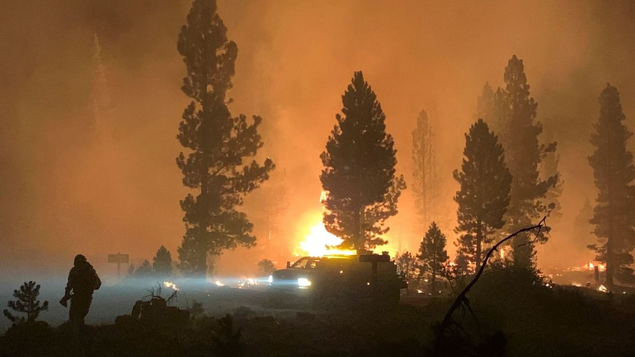 US Forest Service shows a firefighter and rig during night operations on the night of July 17 and early morning of July 18, 2021 at the Bootleg Fire. Credit: AFP Photo