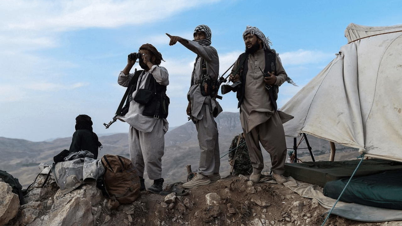 Afghan militia fighters keep a watch at an outpost against Taliban insurgents at Charkint district in Balkh Province. Credit: AFP Photo