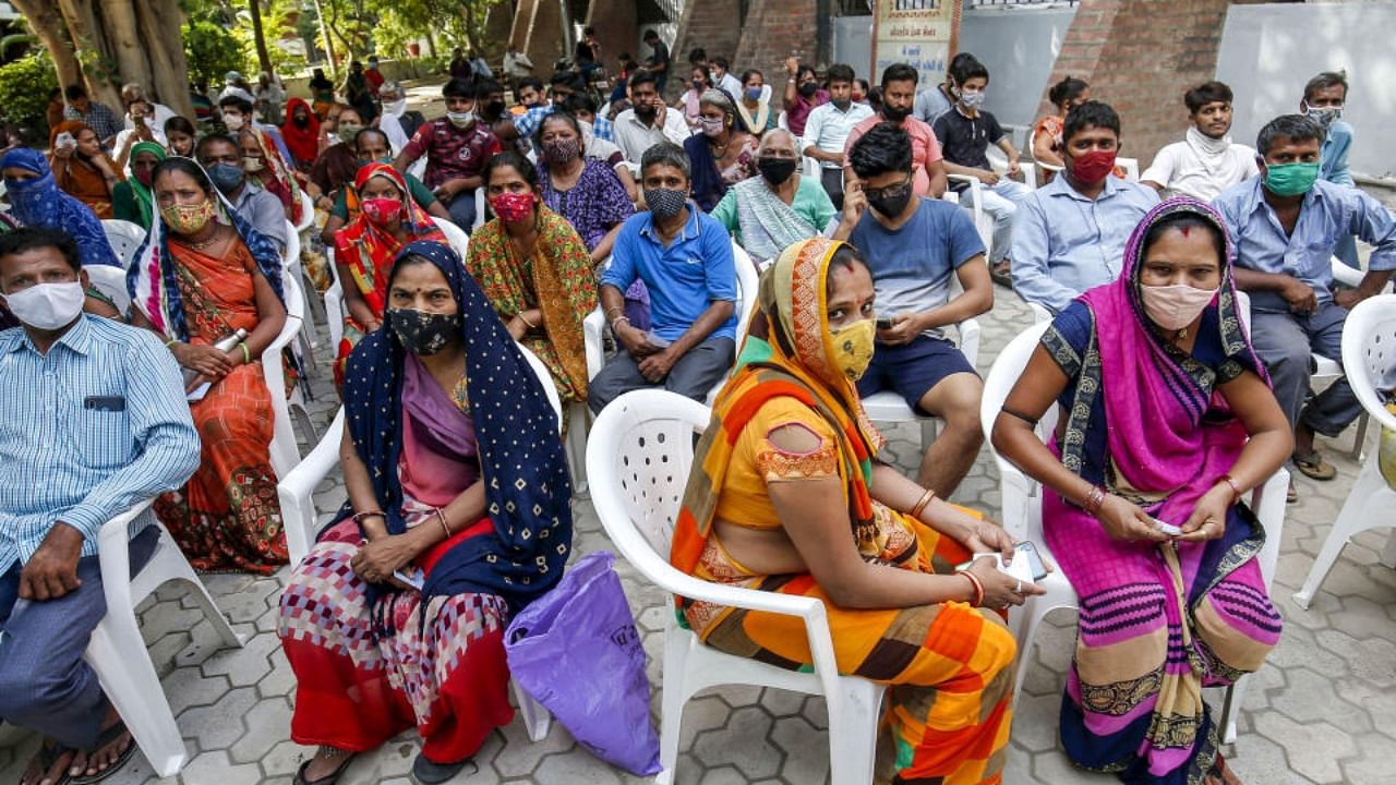 Beneficiaries wait to receive Covid-19 vaccine dose at a vaccination centre in Ahmedabad, Monday, July 5, 2021. Credit: PTI Photo